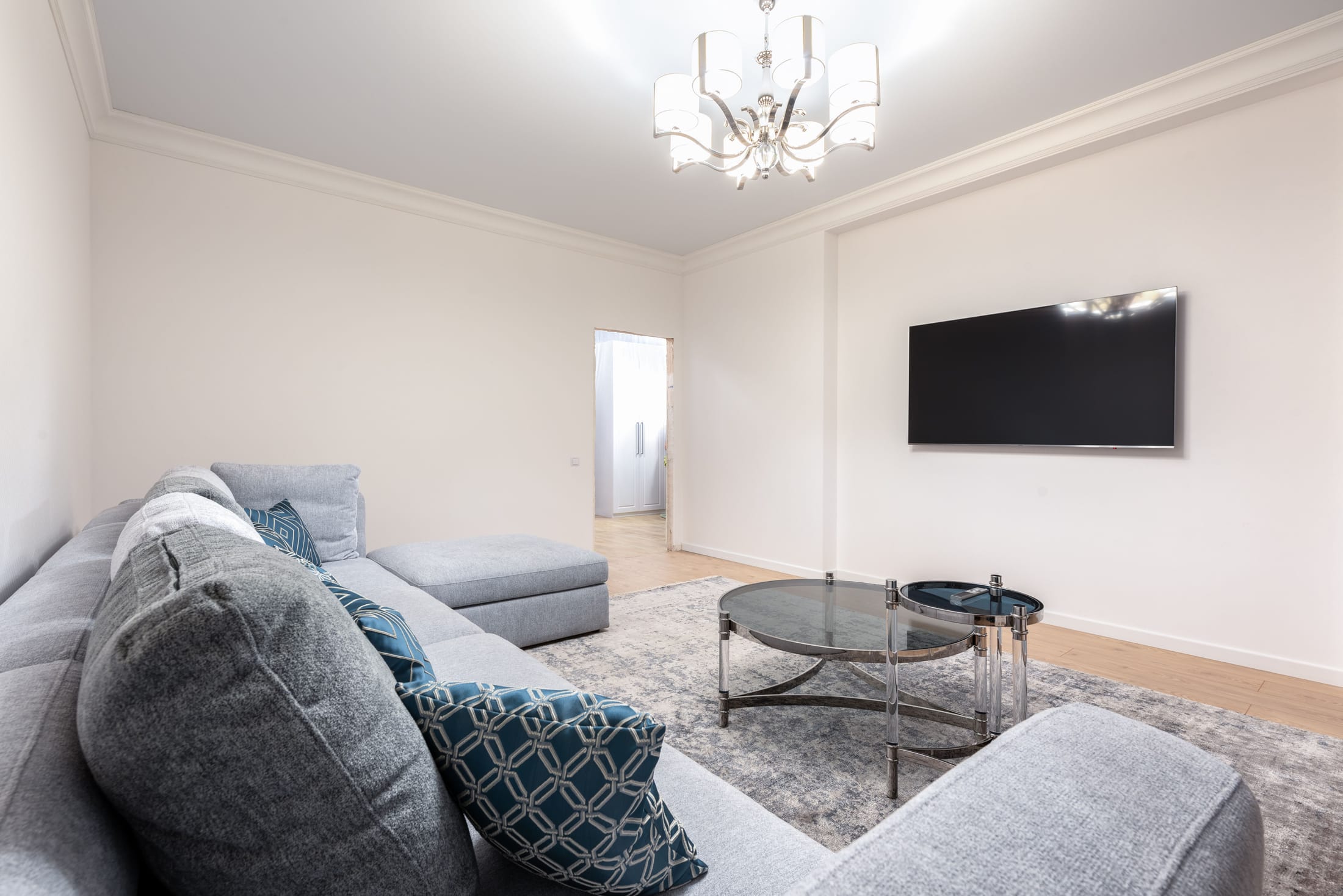 A bright modern living room with a grey sectional sofa