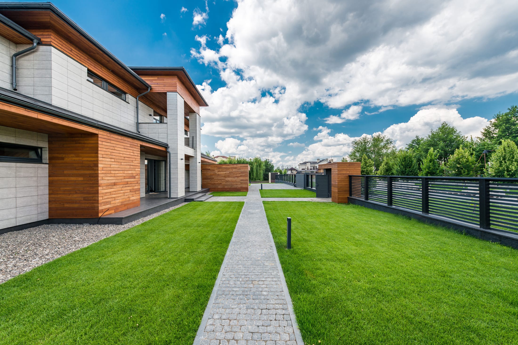 A contemporary house exterior with a landscaped lawn