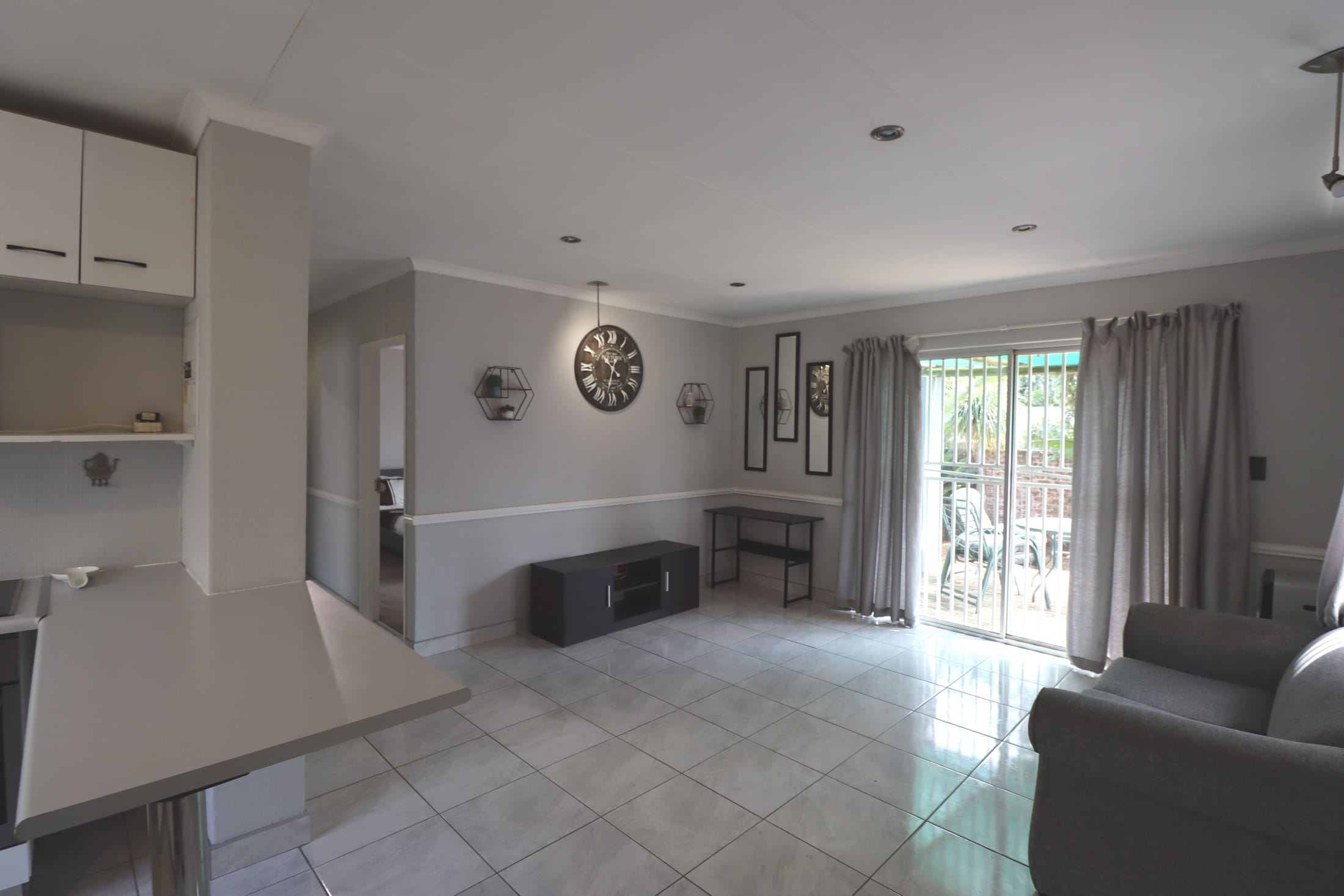 A bright, well-kept open-plan lounge and dining interior, a recent Blu Real Estate listing